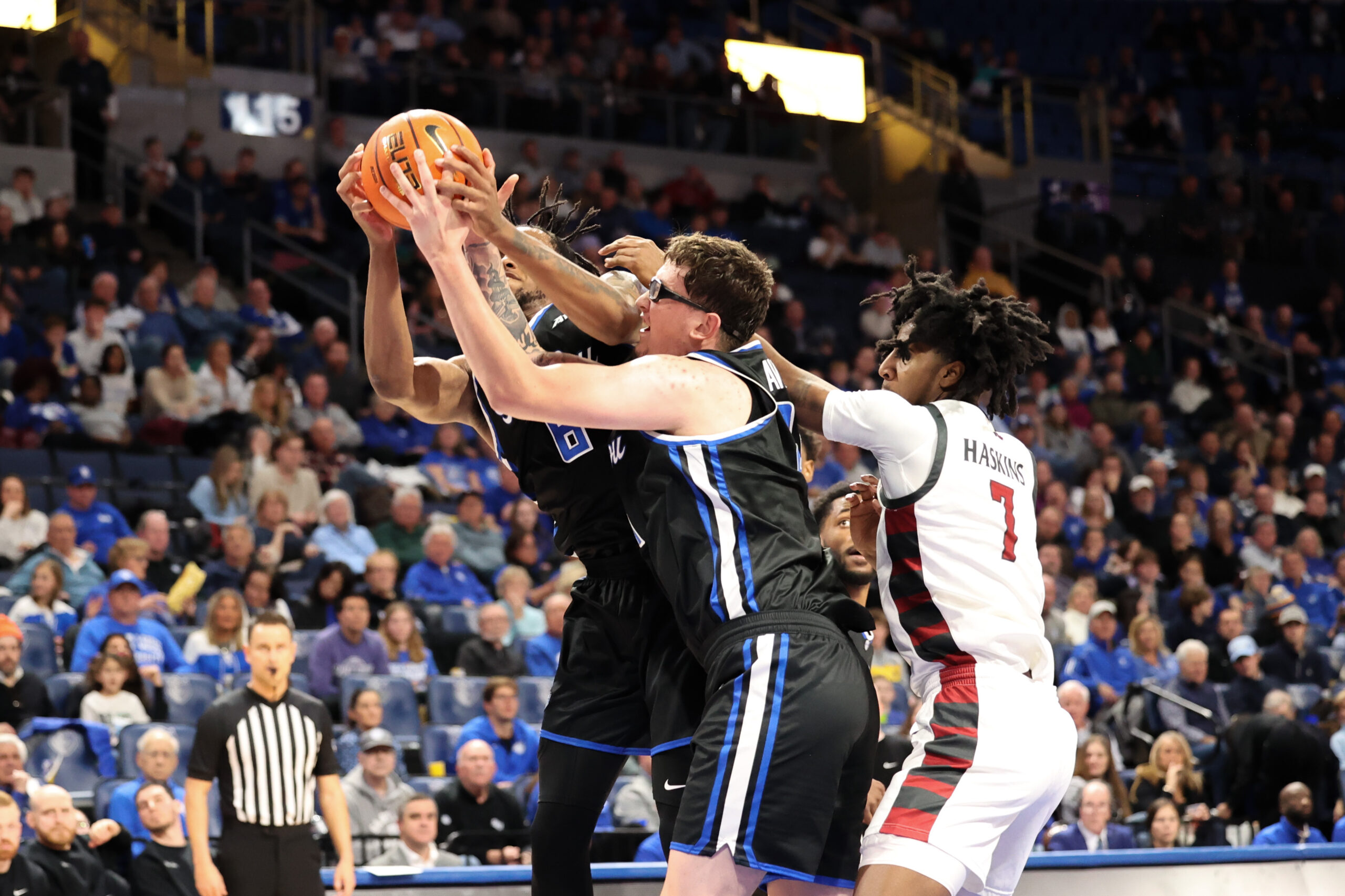 SLU big men Robbie Avila and Kalu Anya pull down a first half rebound
