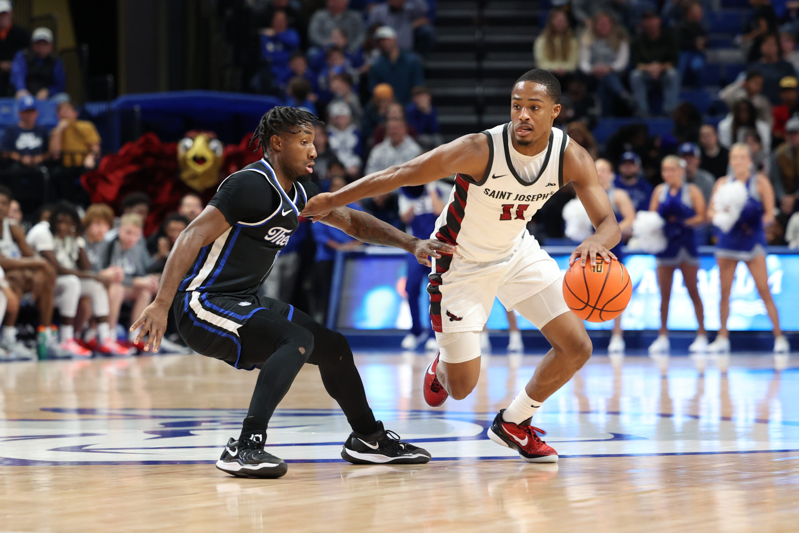 St. Joe sophomore Xzayvier Brown dribbles against SLU's Isaiah Swope