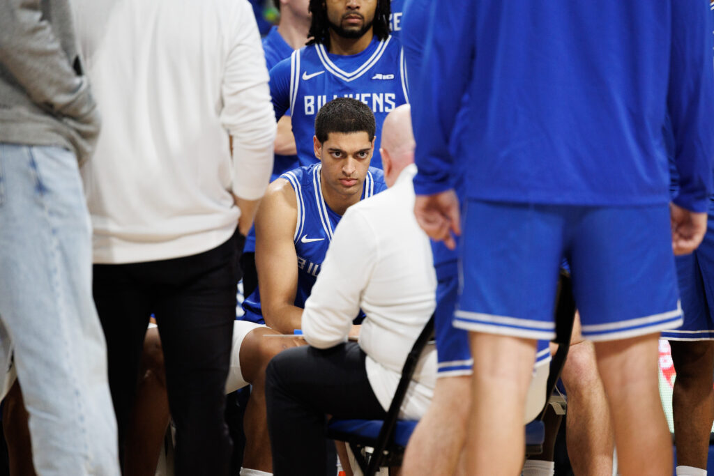 SLU sophomore forward Ishan Sharma listens to instruction from Coach Josh Schertz during a time out. (photo: Jeff Brown)