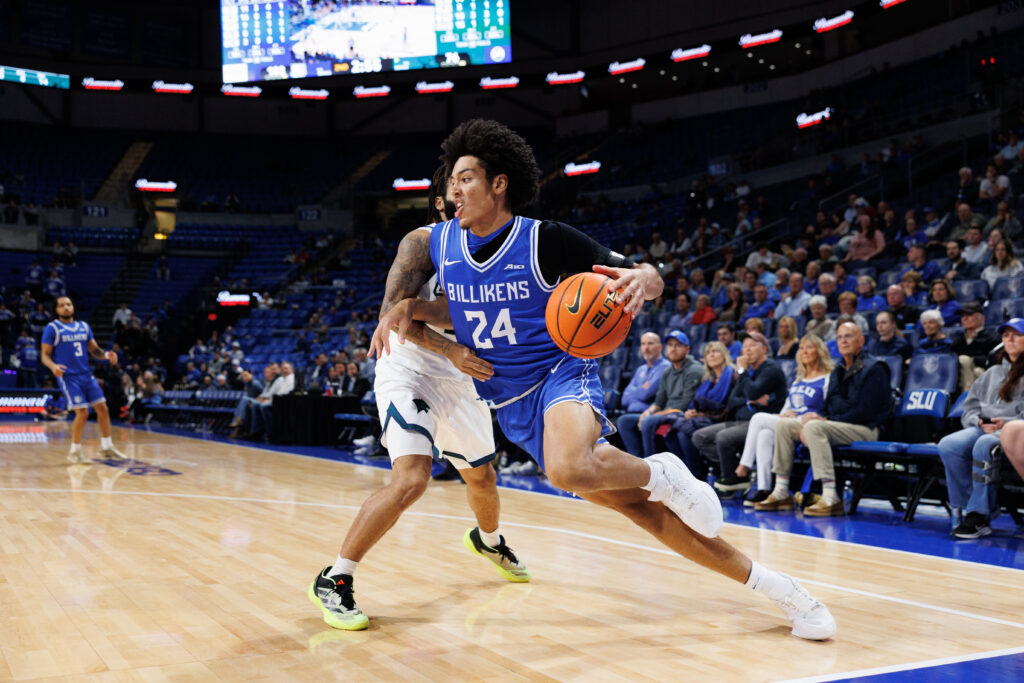 SLU true freshman Cam Hutson drives the baseline past Chicago State's Braelon Bush (photo: Jeff Brown)