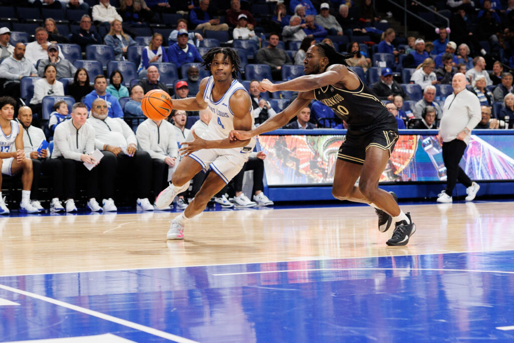 SLU's Amari McCottry drives past Lindenwood University's Jadis Jones (photo: Jeff Brown)
