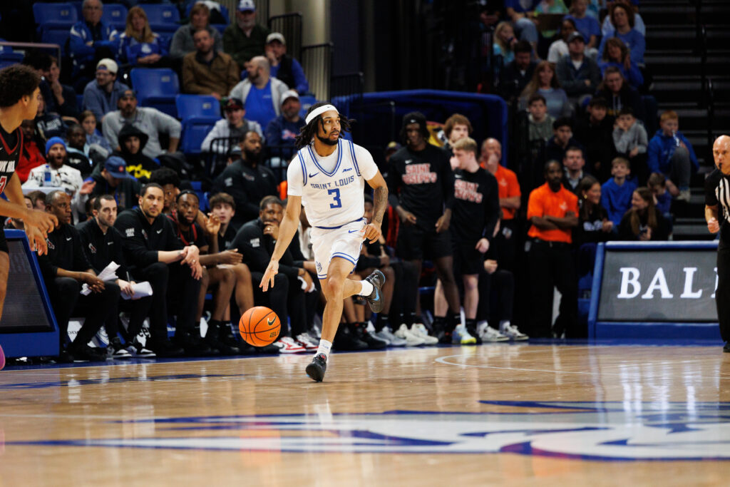 Redshirt Sophomore Trey Green brings the ball upcourt for SLU against St. Joseph's. (photo: Jeff Brown)